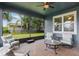 Spacious screened porch with seating area and fenced backyard views at 329 Lake Vista Dr, Auburndale, FL 33823