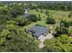 Aerial view of a house with a pool and lush landscaping on a large lot at 856 Twin Oaks Ln, Winter Haven, FL 33880