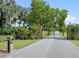 Long driveway leading to a gated entrance with brick pillars at 856 Twin Oaks Ln, Winter Haven, FL 33880