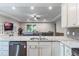 Open concept kitchen with island, granite counters, stainless steel appliances, and view of the living room at 329 Lake Vista Dr, Auburndale, FL 33823