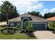 Beautiful blue home with tile roof and palm trees at 329 Lake Vista Dr, Auburndale, FL 33823