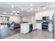 Open concept kitchen with island, granite counters, stainless steel appliances, and view of the living room at 329 Lake Vista Dr, Auburndale, FL 33823