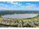 Aerial view of community with lake and surrounding landscape at 329 Lake Vista Dr, Auburndale, FL 33823