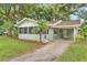 Updated home with a screened porch, carport, and lush landscaping at 1165 E Church St, Bartow, FL 33830