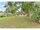 Spacious front yard with lush green grass and mature trees at 1165 E Church St, Bartow, FL 33830