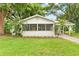 Charming renovated home with a screened porch and manicured lawn at 1165 E Church St, Bartow, FL 33830