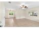Bright living room with tile flooring, ceiling fan, and ample natural light at 1165 E Church St, Bartow, FL 33830