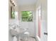 Clean bathroom with white tile and a pedestal sink at 1165 E Church St, Bartow, FL 33830