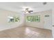 Spacious living area with tile floors, large windows, and a ceiling fan at 1165 E Church St, Bartow, FL 33830