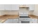 Bright kitchen featuring white cabinets and a modern electric range at 1165 E Church St, Bartow, FL 33830