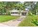 House exterior showcasing a newly renovated home with a screened porch and driveway at 1165 E Church St, Bartow, FL 33830