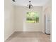 Bright dining area with tile floors, chandelier, and a window overlooking the backyard at 1165 E Church St, Bartow, FL 33830
