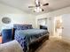 King-size bed in a bedroom with ceiling fan and en-suite bathroom at 902 Charo Pkwy # 624, Davenport, FL 33897