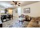 Living room with ample seating and view into dining area at 902 Charo Pkwy # 624, Davenport, FL 33897