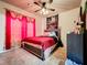 Bedroom with a full-size bed and pink curtains at 902 Charo Pkwy # 624, Davenport, FL 33897