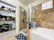 Bathroom with a walk-in shower, soaking tub, and adjacent closet at 902 Charo Pkwy # 624, Davenport, FL 33897