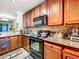 Modern kitchen with granite countertops and dark wood cabinets at 902 Charo Pkwy # 624, Davenport, FL 33897