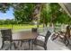 Deck with table and chairs overlooking green space at 801 Polo Park East Blvd, Davenport, FL 33897