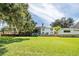 Large backyard with home and screened-in pool at 121 E Lake Summit Dr, Winter Haven, FL 33884
