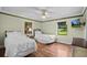 Two twin beds in a well-lit bedroom with hardwood floors at 121 E Lake Summit Dr, Winter Haven, FL 33884