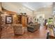 Spacious living room with high ceilings, brick fireplace and tile floors at 121 E Lake Summit Dr, Winter Haven, FL 33884