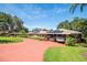 Ranch home with carport and landscaped yard, featuring solar panels at 121 E Lake Summit Dr, Winter Haven, FL 33884