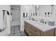 Modern bathroom with double vanity, marble countertop, and black and white tile at 121 E Lake Summit Dr, Winter Haven, FL 33884