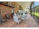Relaxing screened patio with brick flooring, outdoor dining set, and built-in grill at 121 E Lake Summit Dr, Winter Haven, FL 33884