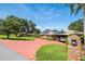 Brick ranch home with solar panels and circular driveway, offering curb appeal at 121 E Lake Summit Dr, Winter Haven, FL 33884