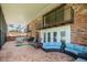 Spacious screened patio with brick flooring, comfortable seating, and access to backyard at 121 E Lake Summit Dr, Winter Haven, FL 33884