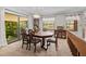 Bright dining room with a large table and access to a balcony at 121 E Lake Summit Dr, Winter Haven, FL 33884