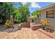 Landscaped walkway leading to the home with lush tropical plants and brick pavers at 121 E Lake Summit Dr, Winter Haven, FL 33884