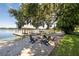 Lakefront firepit area with Adirondack chairs under oak tree at 121 E Lake Summit Dr, Winter Haven, FL 33884