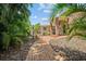 Brick walkway meanders through landscaping, leading to the home's entrance at 121 E Lake Summit Dr, Winter Haven, FL 33884