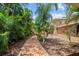 Brick walkway leading to home with lush tropical landscaping at 121 E Lake Summit Dr, Winter Haven, FL 33884