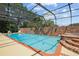 Resort-style pool and spa, complete with a screened enclosure and brick coping at 121 E Lake Summit Dr, Winter Haven, FL 33884