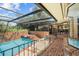 Inviting pool and spa area with brick decking and a screened enclosure at 121 E Lake Summit Dr, Winter Haven, FL 33884