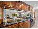 Kitchen boasts granite countertops and dark wood cabinets at 121 E Lake Summit Dr, Winter Haven, FL 33884
