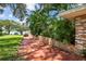 Side yard with brick wall and lake view at 121 E Lake Summit Dr, Winter Haven, FL 33884
