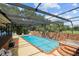 Large screened-in pool and jacuzzi with brick deck at 121 E Lake Summit Dr, Winter Haven, FL 33884