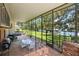 Large screened patio with brick flooring, outdoor dining, and a grilling area at 121 E Lake Summit Dr, Winter Haven, FL 33884