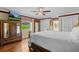 King-size bed, large dresser, and window with scenic view at 121 E Lake Summit Dr, Winter Haven, FL 33884