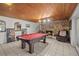 Basement recreation room with pool table and stone fireplace at 121 E Lake Summit Dr, Winter Haven, FL 33884