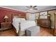 Elegant main bedroom with a king-size bed and wood dresser at 121 E Lake Summit Dr, Winter Haven, FL 33884