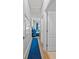 Clean hallway with blue runner and access to bedrooms at 2158 Mirasol Dr, Winter Haven, FL 33881