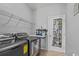 Laundry room with washer, dryer, and shelving at 2158 Mirasol Dr, Winter Haven, FL 33881