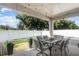 Covered patio with table and chairs, perfect for outdoor dining at 2158 Mirasol Dr, Winter Haven, FL 33881