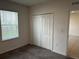 Bright bedroom with carpet flooring and a double-door closet at 177 Cimarron Ln, Kissimmee, FL 34759