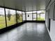 Spacious screened porch with concrete flooring, overlooks backyard at 177 Cimarron Ln, Kissimmee, FL 34759