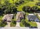 Aerial view of three homes, showcasing landscaping and neighborhood at 2158 Mirasol Dr, Winter Haven, FL 33881